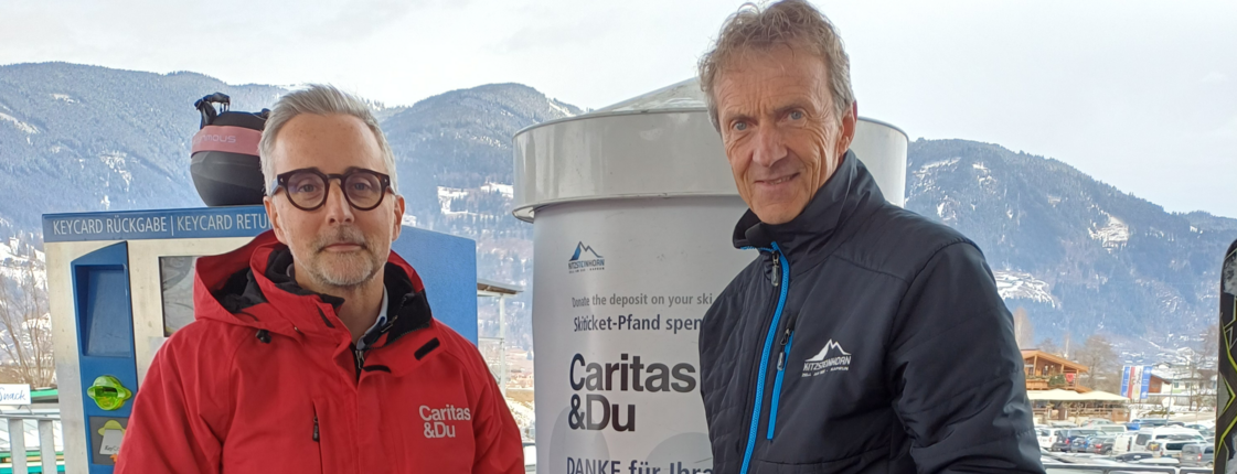 Zwei Männer vor einer Spendenbox