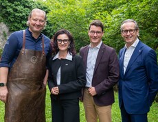 3 Männer und eine Frau lachen in die Kamera