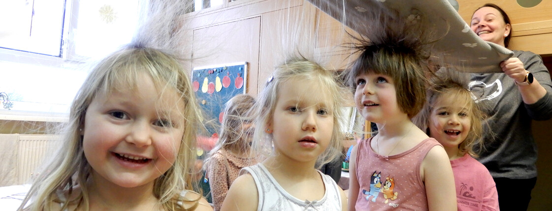 vier jungen Mädchen stehen die Haare zu Berge